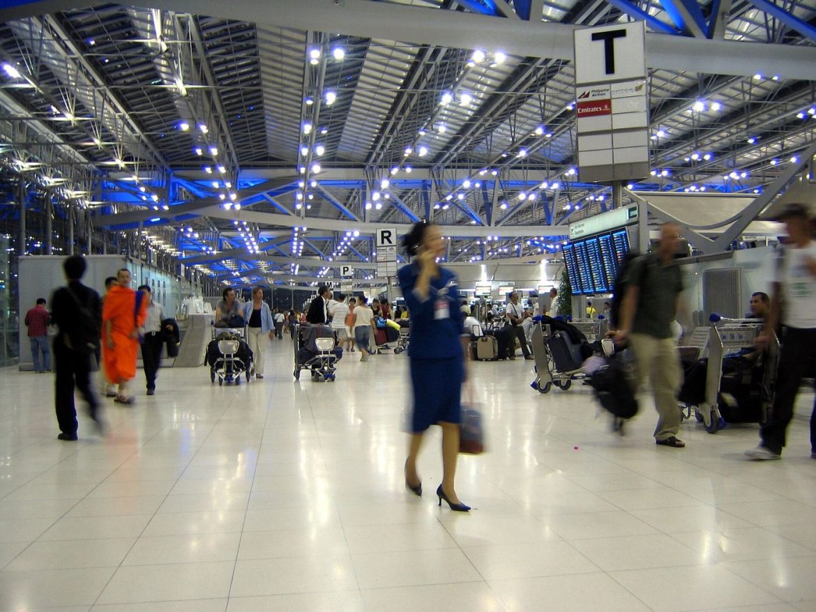 Passengers moving through an airport terminal